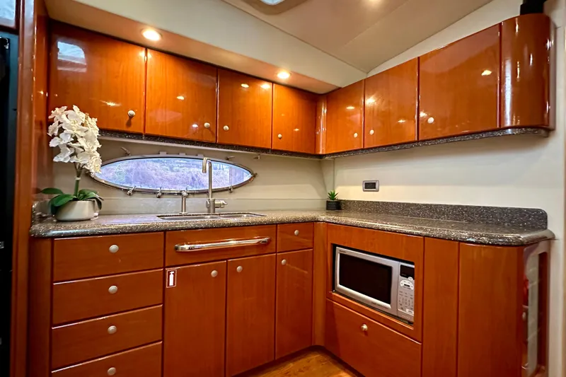 Formula 45 Yacht Photos Pics Luxurious kitchen interior of 2008 Formula 45 Yacht with wood cabinets and modern appliances.