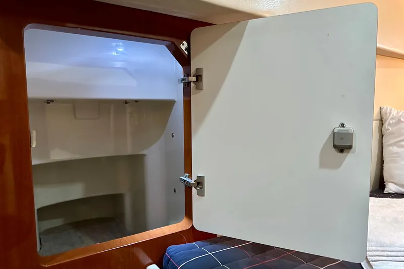 Formula 45 Yacht Photos Pics Open storage cabinet inside 2008 Formula 45 Yacht, featuring wooden frame and white interior.