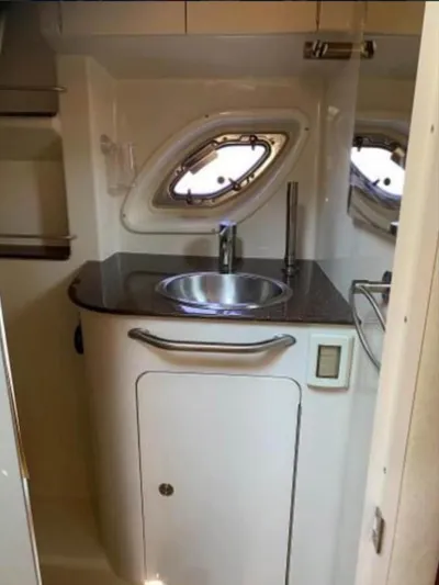  Yacht Photos Pics 2013 Sea Ray 330 Sundancer bathroom with sink and porthole window.