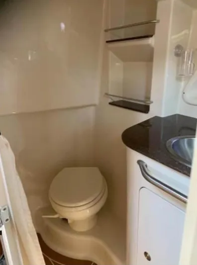  Yacht Photos Pics 2013 Sea Ray 330 Sundancer bathroom with toilet, sink, and shelves.