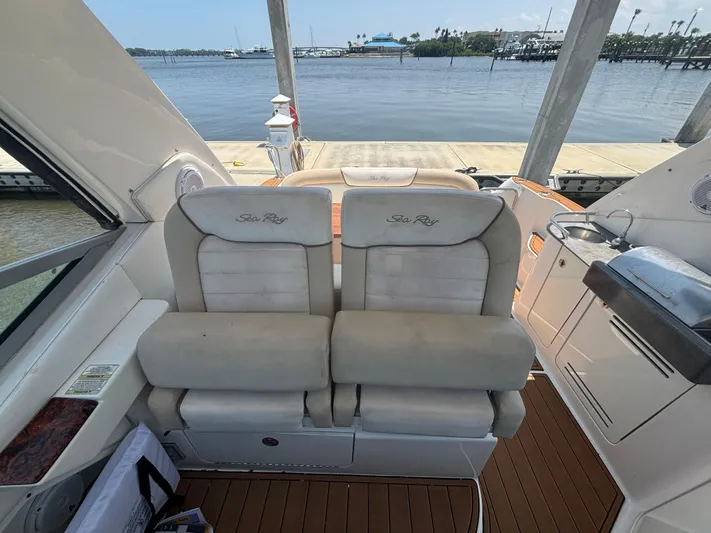  Yacht Photos Pics 2013 Sea Ray 330 Sundancer boat interior with plush seating and scenic waterfront view.