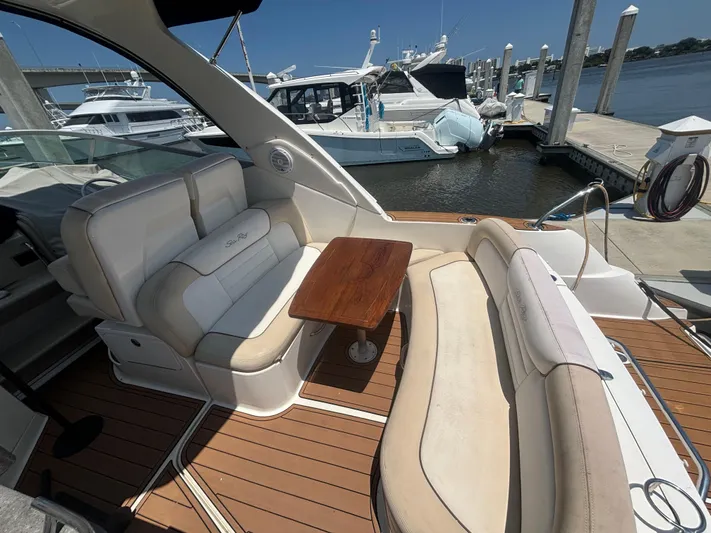  Yacht Photos Pics 2013 Sea Ray 330 Sundancer yacht interior with seating and table at marina.