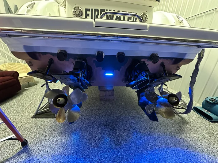  Yacht Photos Pics 2014 Formula 370 Super Sport boat with illuminated dual propellers in a garage setting.