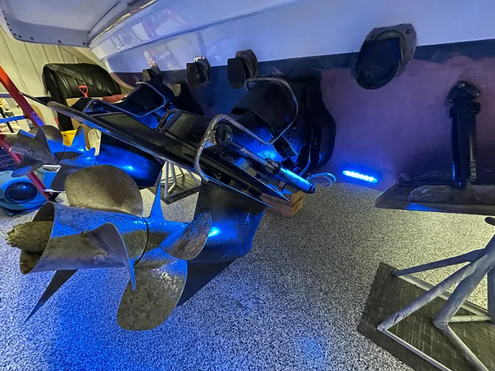  Yacht Photos Pics 2014 Formula 370 Super Sport boat propellers with blue LED lighting in a garage setting.