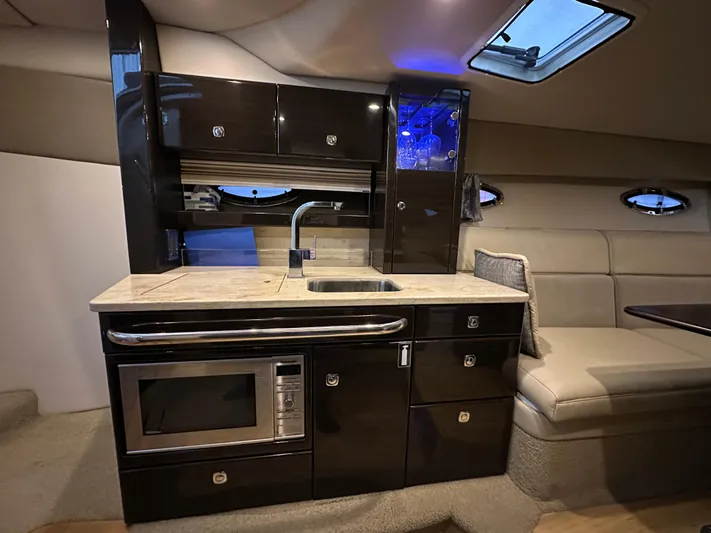  Yacht Photos Pics Luxurious interior of 2014 Formula 370 Super Sport yacht with modern kitchenette and seating area.