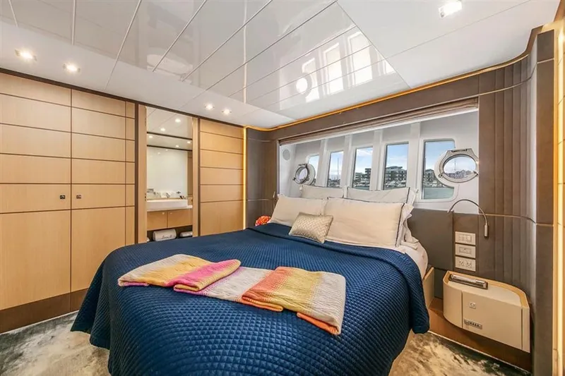 Lontano Yacht Photos Pics Luxurious bedroom interior of 2016 Ferretti 960 yacht with modern design and cozy bedding.