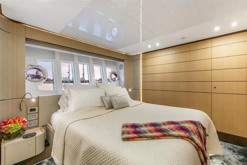 Lontano Yacht Photos Pics Luxurious bedroom interior of 2016 Ferretti 960 yacht with elegant decor and large windows.