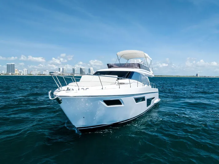 Ferretti 500 Yacht Photos Pics 2024 Ferretti Yachts 500 cruising on open water under clear blue skies.