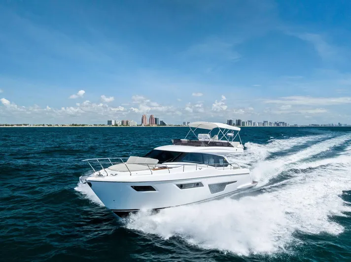 Ferretti 500 Yacht Photos Pics 2024 Ferretti Yachts 500 cruising on open water under a clear blue sky.