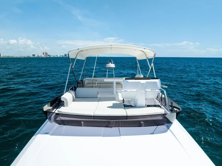 Ferretti 500 Yacht Photos Pics 2024 Ferretti Yachts 500 on open sea, showcasing luxurious deck and seating area.