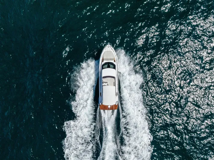 Ferretti 500 Yacht Photos Pics Aerial view of 2024 Ferretti Yachts 500 cruising on open water.