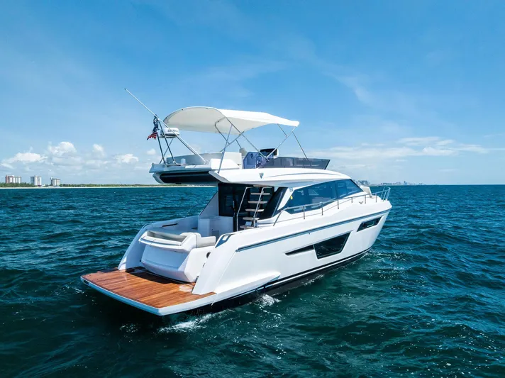 Ferretti 500 Yacht Photos Pics 2024 Ferretti Yachts 500 cruising on open sea under clear blue sky.