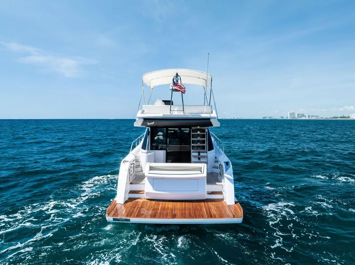 Ferretti 500 Yacht Photos Pics 2024 Ferretti Yachts 500 cruising on open sea, rear view.