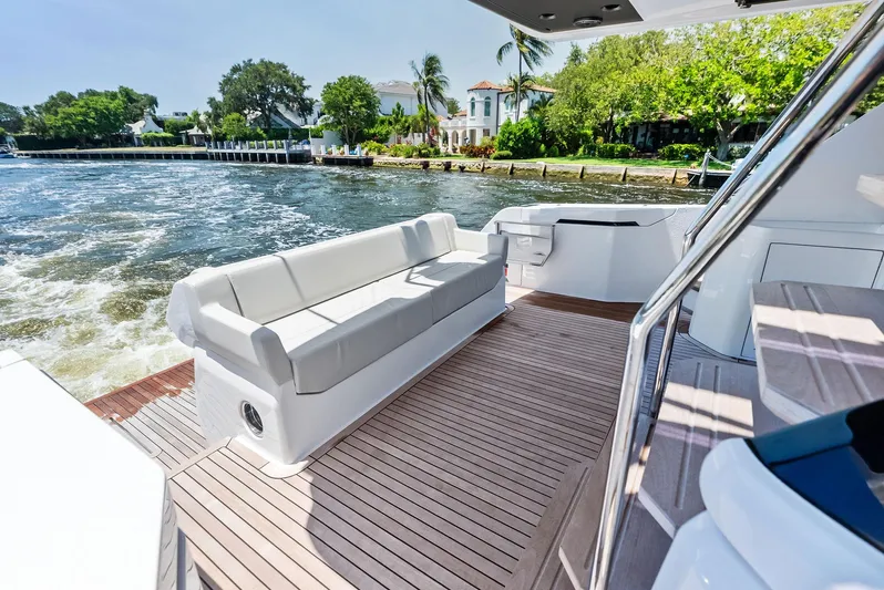 Ferretti 500 Yacht Photos Pics 2024 Ferretti Yachts 500 deck with seating, cruising on a scenic waterway.