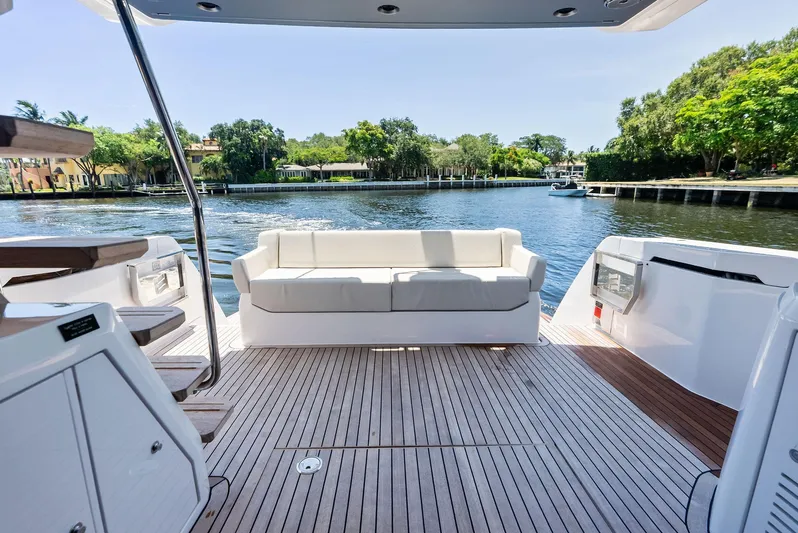 Ferretti 500 Yacht Photos Pics Luxurious 2024 Ferretti Yachts 500 deck with white seating and scenic waterfront view.