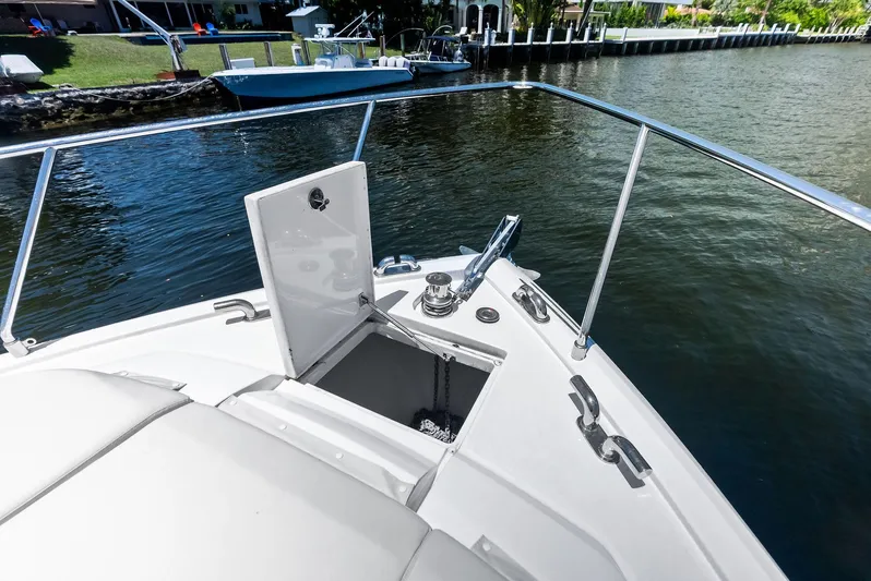 Ferretti 500 Yacht Photos Pics 2024 Ferretti Yachts 500 bow with anchor compartment open on calm water.