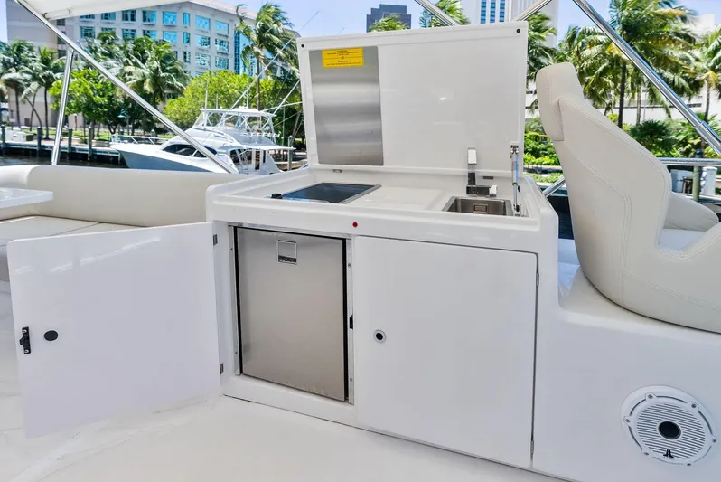 Ferretti 500 Yacht Photos Pics 2024 Ferretti Yachts 500 outdoor kitchenette with sink and seating area.