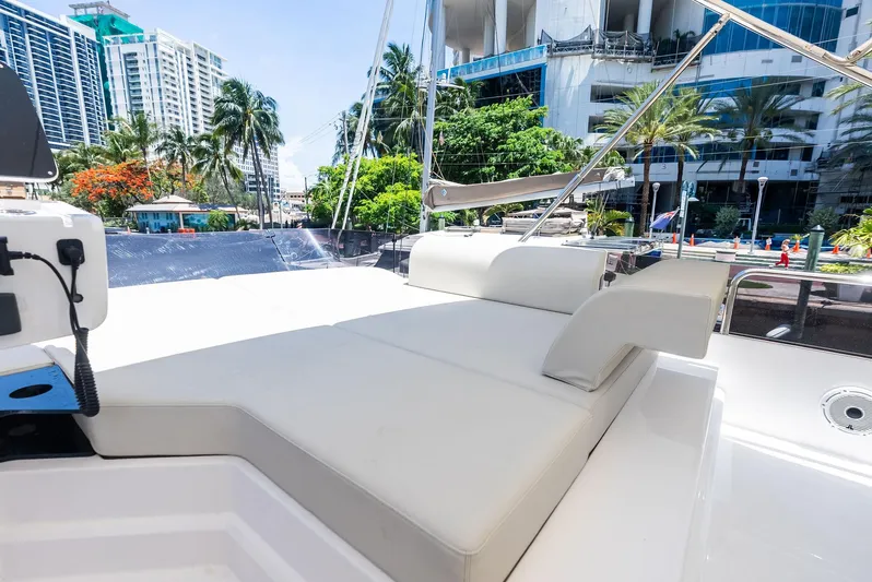 Ferretti 500 Yacht Photos Pics Luxurious 2024 Ferretti Yachts 500 deck with cityscape and palm trees in the background.