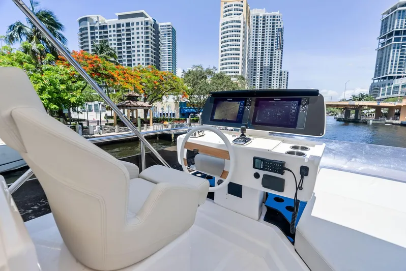 Ferretti 500 Yacht Photos Pics 2024 Ferretti Yachts 500 helm with cityscape backdrop, featuring modern navigation equipment.