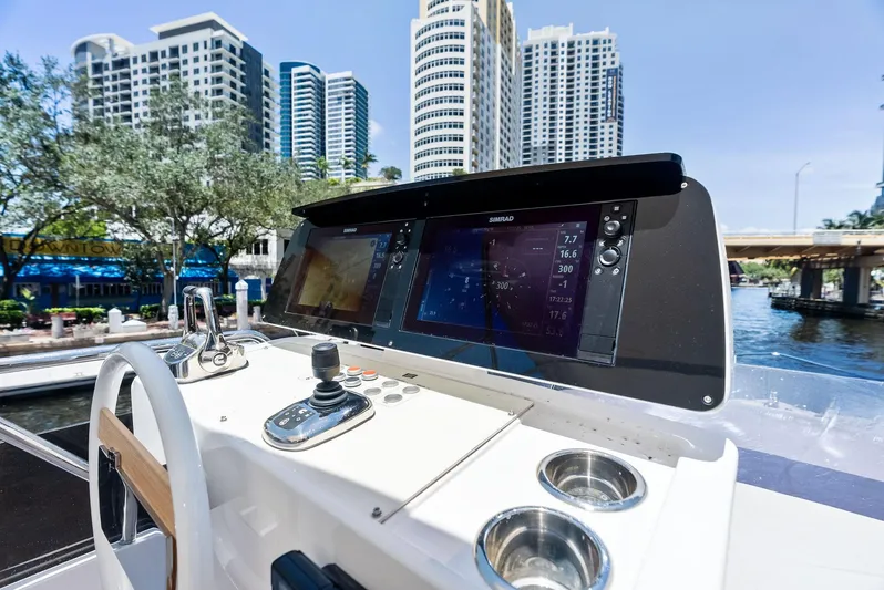Ferretti 500 Yacht Photos Pics 2024 Ferretti Yachts 500 helm with modern navigation displays, cityscape in background.
