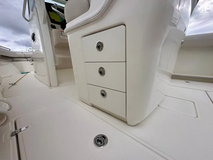  Yacht Photos Pics 2019 Boston Whaler 280 Outrage interior with storage drawers and sleek design.