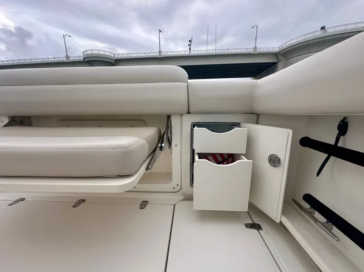 Yacht Photos Pics 2019 Boston Whaler 280 Outrage interior with storage compartment and cushioned seating.