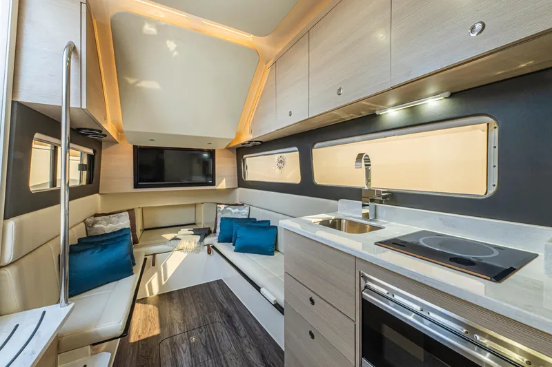  Yacht Photos Pics Luxurious interior of 2023 Scout 425 LXF yacht with modern kitchen and seating area.
