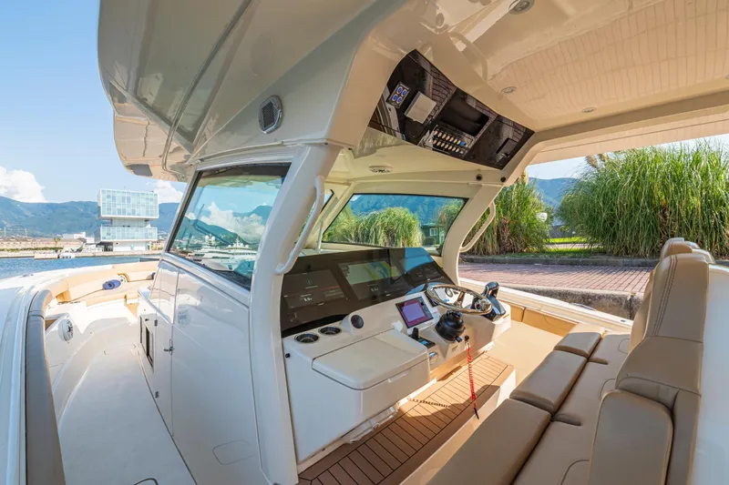  Yacht Photos Pics 2023 Scout 425 LXF boat interior with modern helm and luxurious seating.