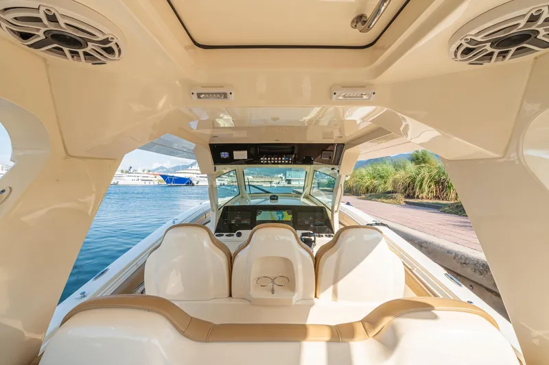  Yacht Photos Pics Interior view of 2023 Scout 425 LXF boat, featuring luxurious seating and advanced navigation system.