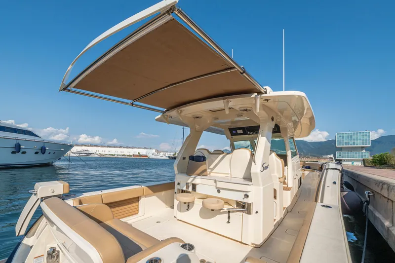  Yacht Photos Pics 2023 Scout 425 LXF boat docked, featuring spacious seating and modern design.