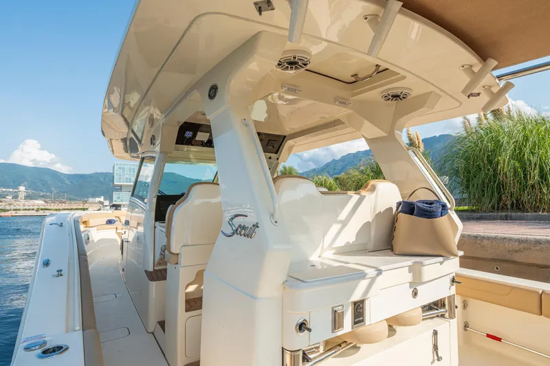  Yacht Photos Pics 2023 Scout 425 LXF luxury boat interior with seating and scenic waterfront view.