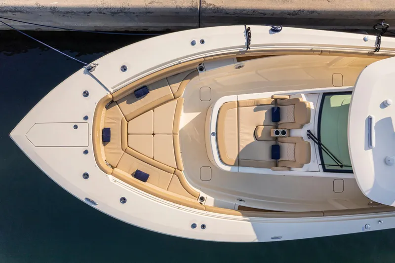  Yacht Photos Pics 2023 Scout 425 LXF boat with luxurious seating and sleek design, docked at marina.