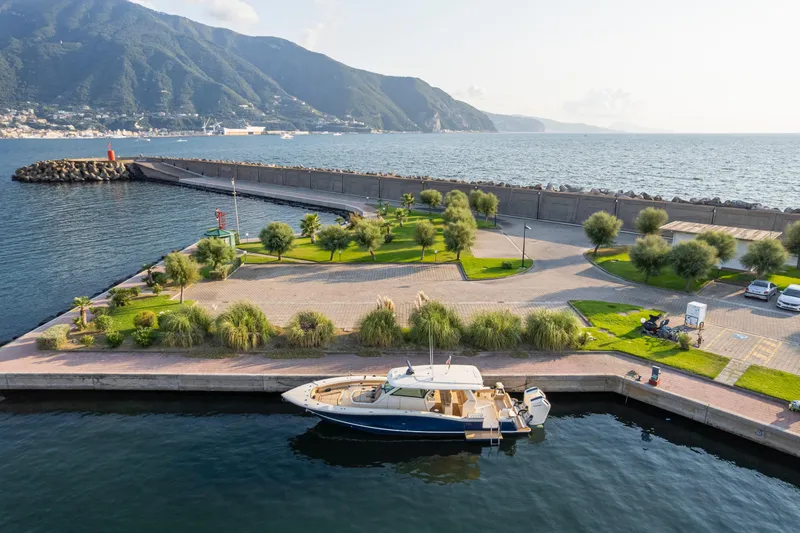  Yacht Photos Pics 2023 Scout 425 LXF yacht docked at scenic marina with mountain backdrop.