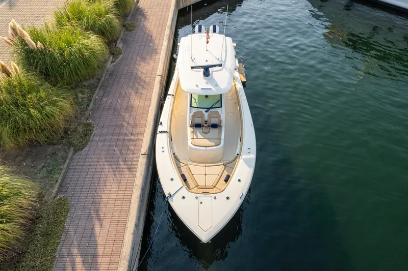  Yacht Photos Pics 2023 Scout 425 LXF boat docked beside a walkway, aerial view.