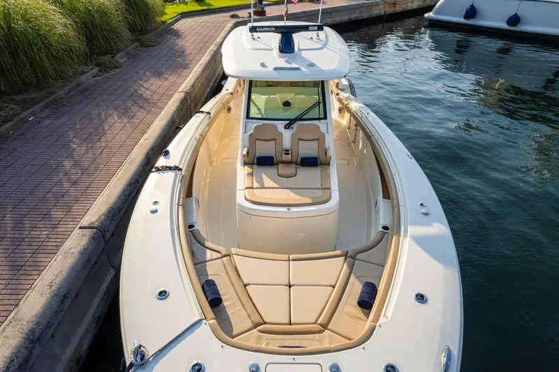  Yacht Photos Pics 2023 Scout 425 LXF boat docked, featuring spacious seating and sleek design.