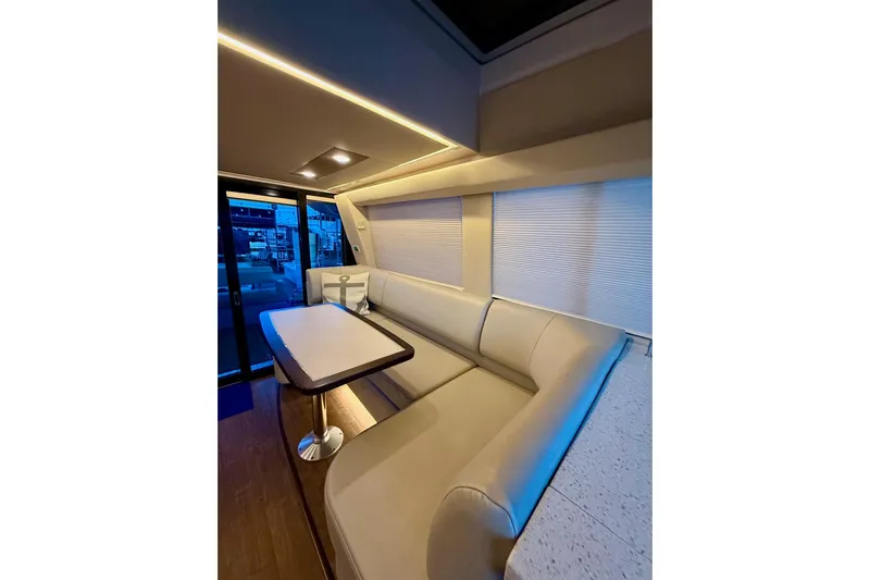  Yacht Photos Pics Luxurious interior of 2018 Regal 42 Grande Coupe yacht with elegant seating and table.