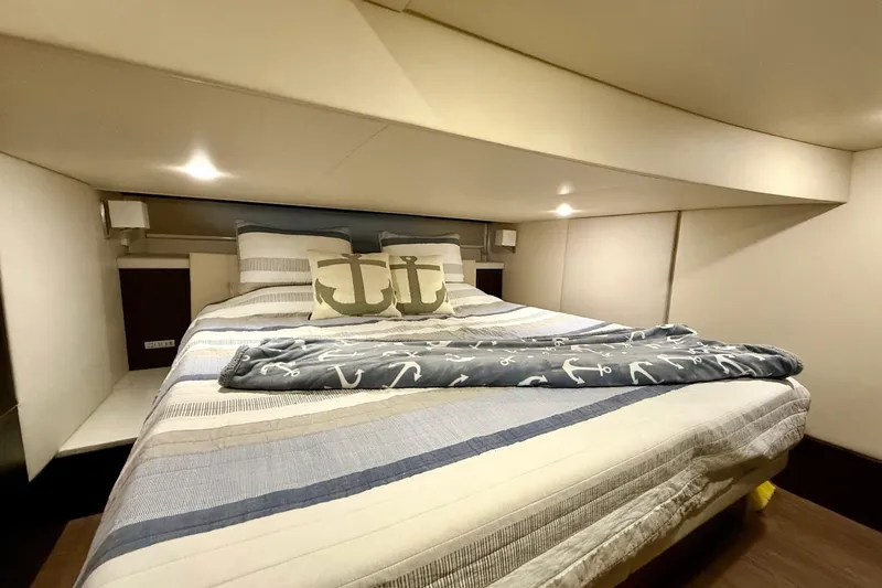  Yacht Photos Pics Luxurious bedroom interior of 2018 Regal 42 Grande Coupe yacht with nautical-themed bedding.
