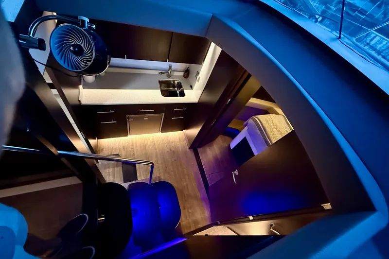  Yacht Photos Pics Luxurious interior of 2018 Regal 42 Grande Coupe yacht with modern kitchen and cozy bedroom.