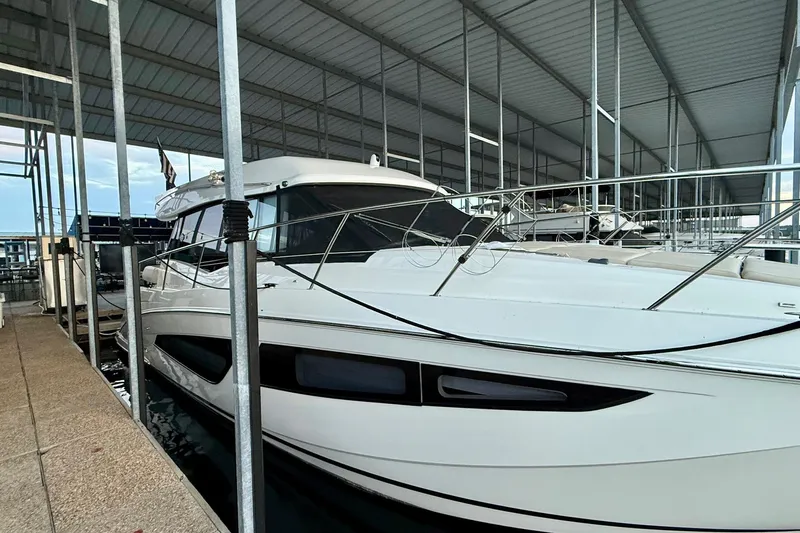  Yacht Photos Pics 2018 Regal 42 Grande Coupe yacht docked in a covered marina.