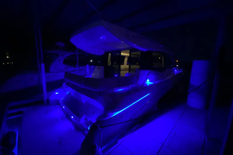  Yacht Photos Pics 2018 Regal 42 Grande Coupe yacht illuminated with blue lights at night.