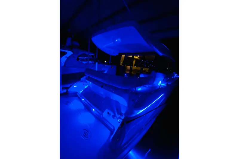 Yacht Photos Pics 2018 Regal 42 Grande Coupe yacht illuminated with blue LED lights at night.