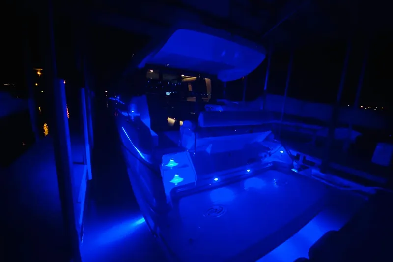  Yacht Photos Pics 2018 Regal 42 Grande Coupe yacht illuminated with blue LED lights at night.