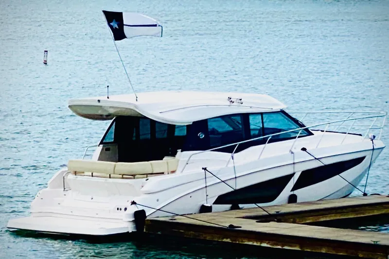  Yacht Photos Pics 2018 Regal 42 Grande Coupe yacht docked on calm water.