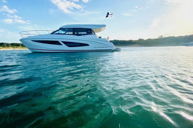  Yacht Photos Pics 2018 Regal 42 Grande Coupe yacht on serene water under a clear blue sky.