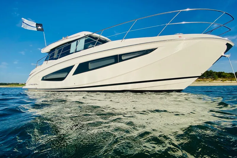  Yacht Photos Pics 2018 Regal 42 Grande Coupe yacht on water, clear blue sky background.
