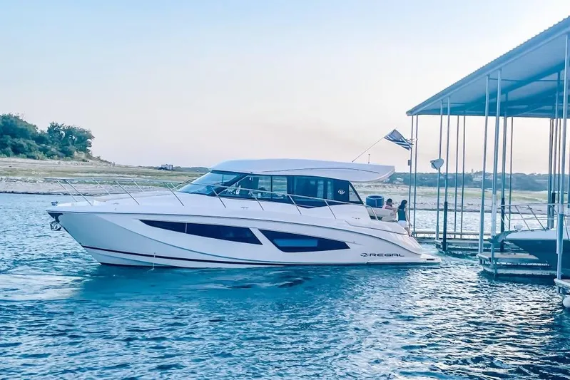  Yacht Photos Pics 2018 Regal 42 Grande Coupe yacht docked on serene water.