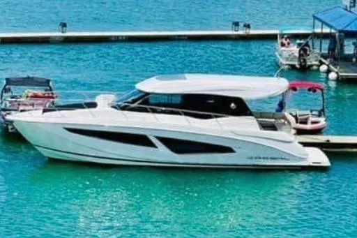  Yacht Photos Pics 2018 Regal 42 Grande Coupe yacht docked on turquoise water.