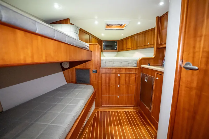 Here Fishy Fishy Yacht Photos Pics Interior of 2012 Winter Custom Yachts 38 Express with wooden cabinetry and bunk beds.