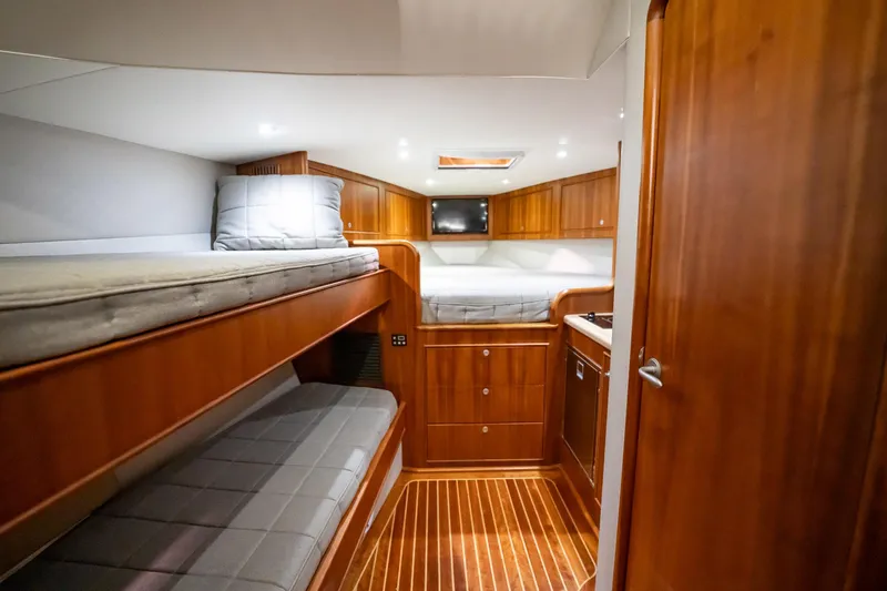 Here Fishy Fishy Yacht Photos Pics Luxurious 2012 Winter Custom Yachts 38 Express cabin with wooden interior and cozy bunks.