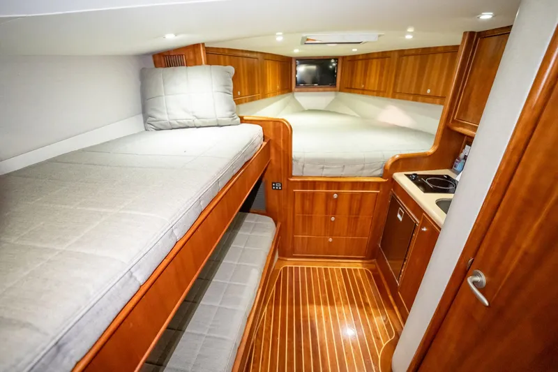 Here Fishy Fishy Yacht Photos Pics Luxurious 2012 Winter Custom Yachts 38 Express cabin with wooden interior and cozy beds.
